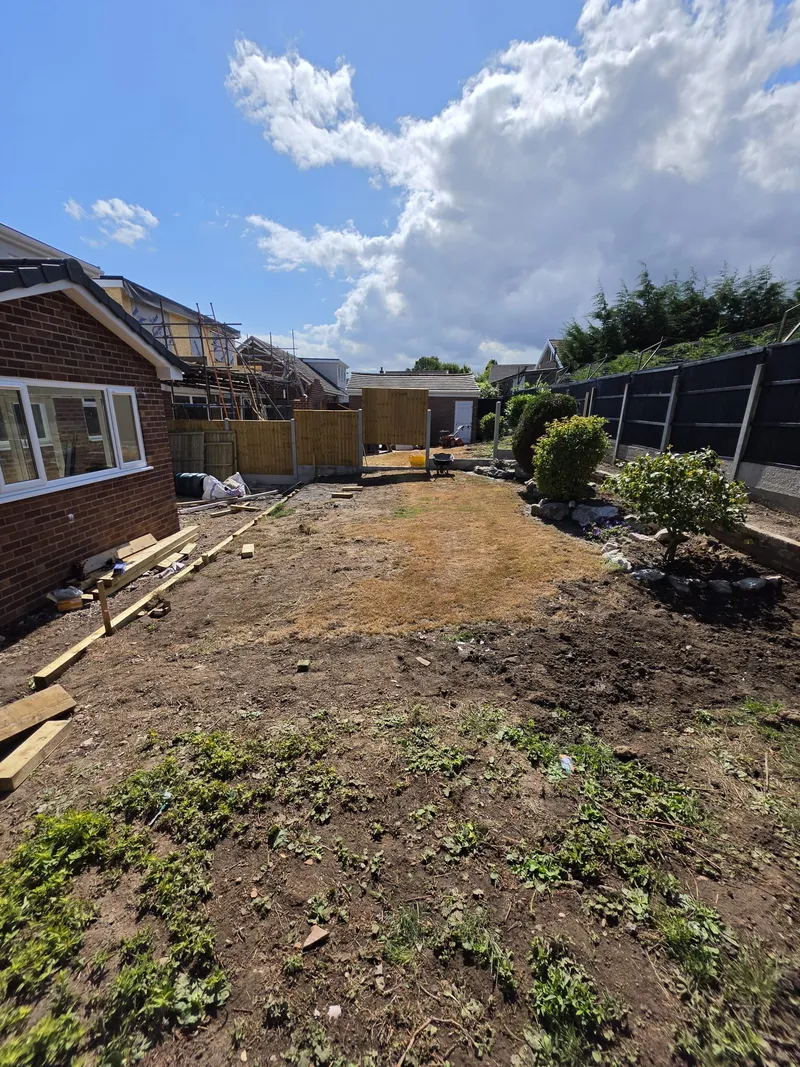 Runcorn back garden before turfing: cleared, uneven ground ready for preparation
